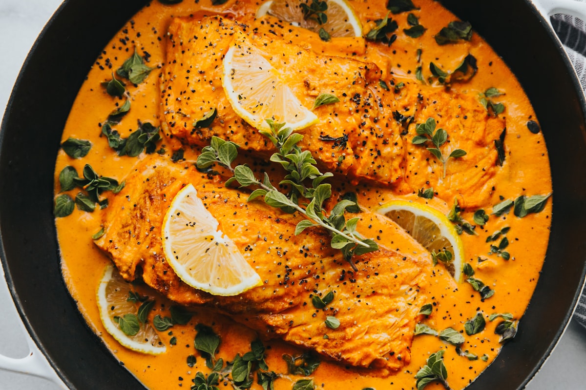 Baked salmon fillet with asparagus on a white plate