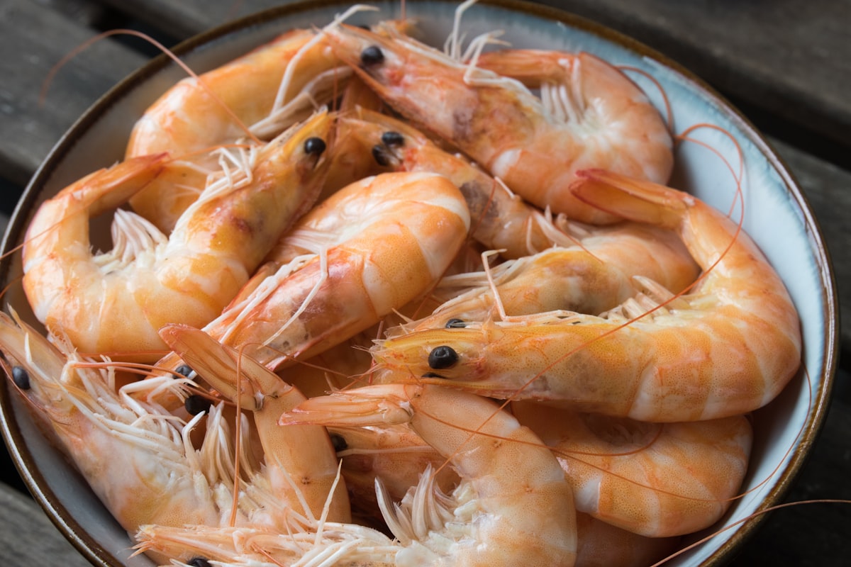 Garlic butter shrimp scampi in a skillet with parsley