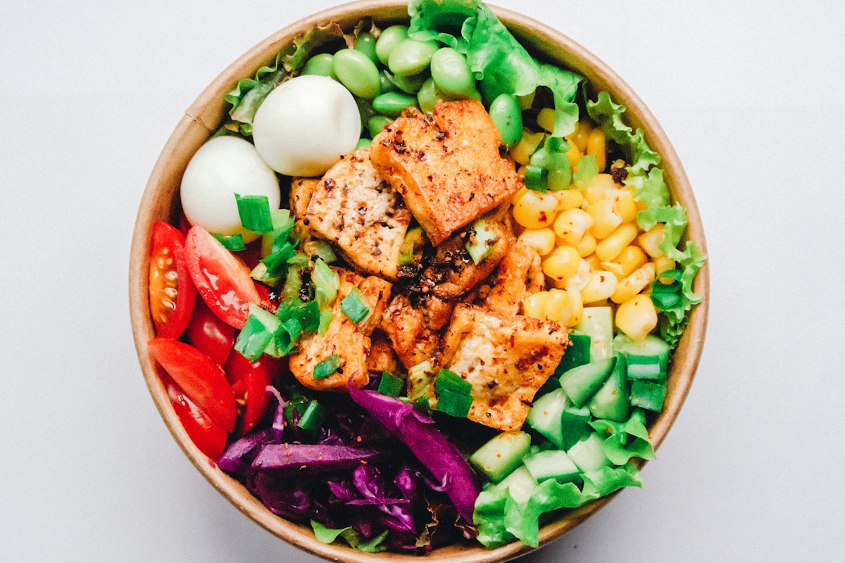 Salmon poke bowl with rice, avocado, and vegetables